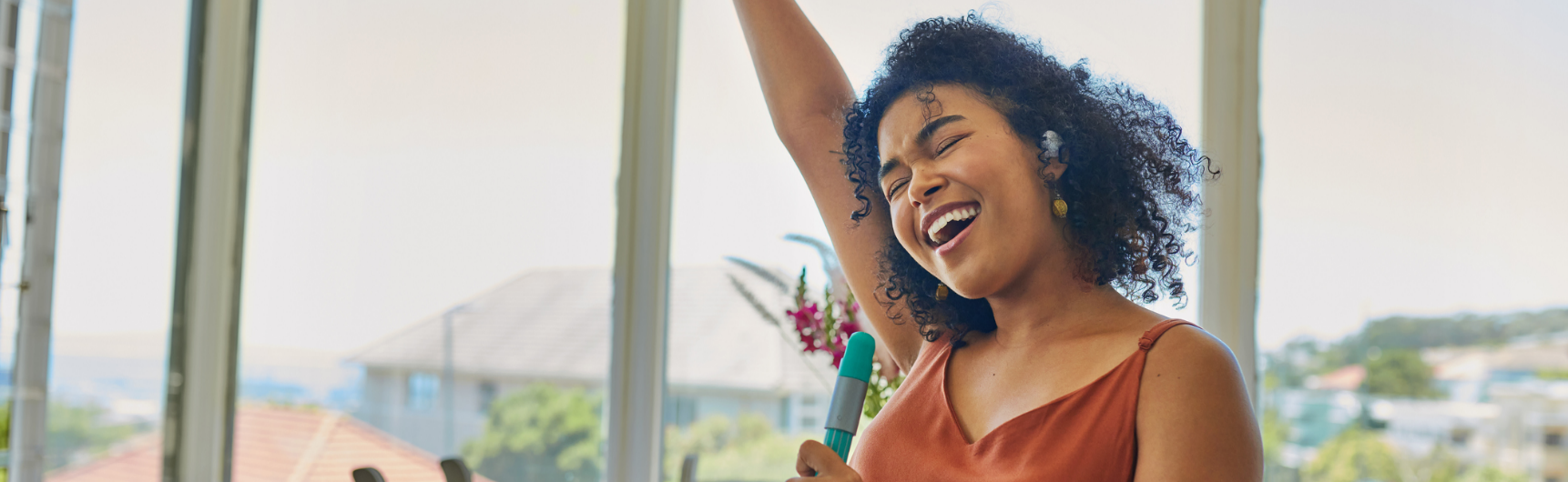 A woman dances while she does the housework