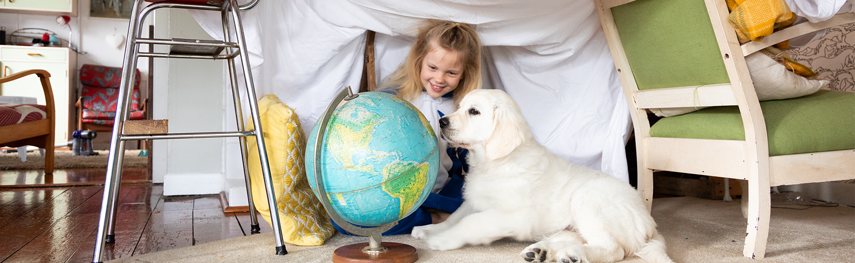 Girl and Puppy looking a globe